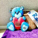 Blue Teddy Bear with Medal on Wicker Basket