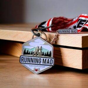 Running Mad finisher medal draped on wooden surface.