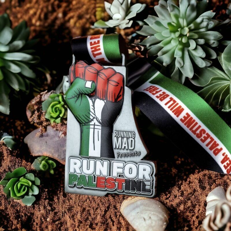 Run for Palestine medal with red fist, green ribbon on blue bokeh background