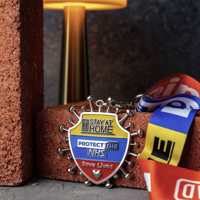 NHS medal propped against a brick background