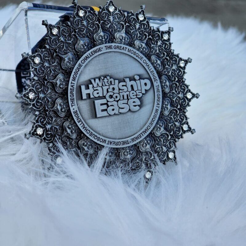 Inspirational running medal with intricate floral design and motivational message