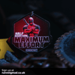 Deadpool comedic action pose running medal with vibrant colors.