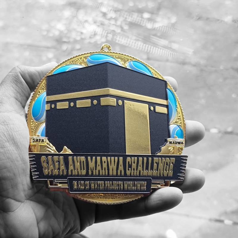 Hand-Holding Safa and Marwa Charity Medal with Selective Colour Effect"