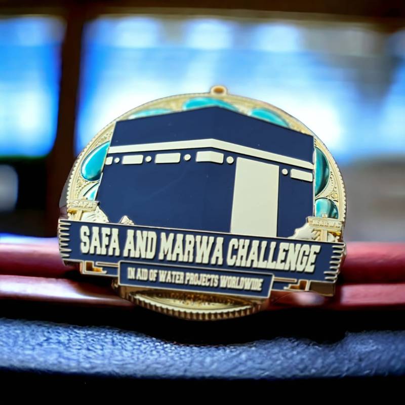 Elegant Safa and Marwa Water Aid Challenge Medal on Velvet Texture