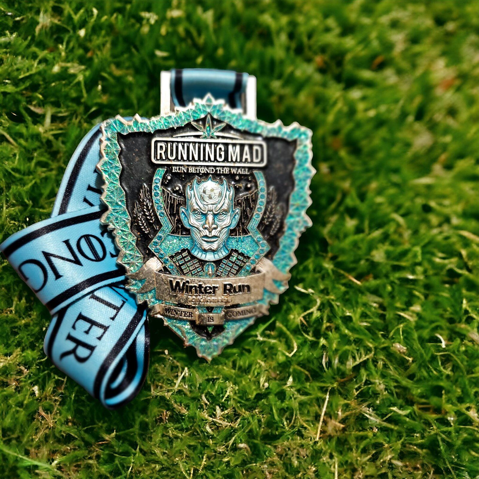 Game of Thrones Themed Winter Run Challenge Medal on Lush Greenery